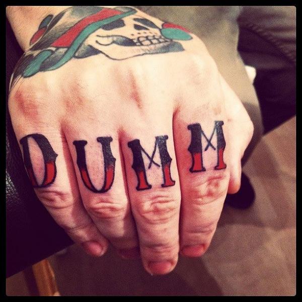 Finger DUMM Lettering tattoo by Sarah B Bolen