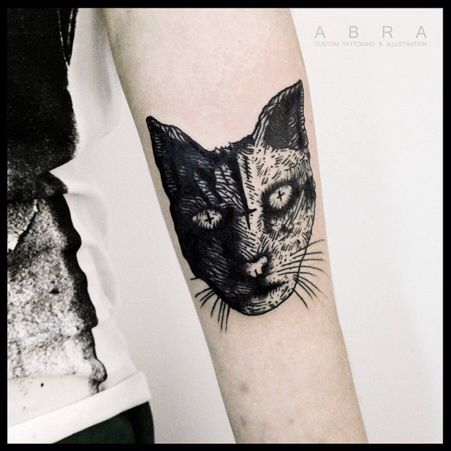 Crosses in Eyes Cat Arm tattoo