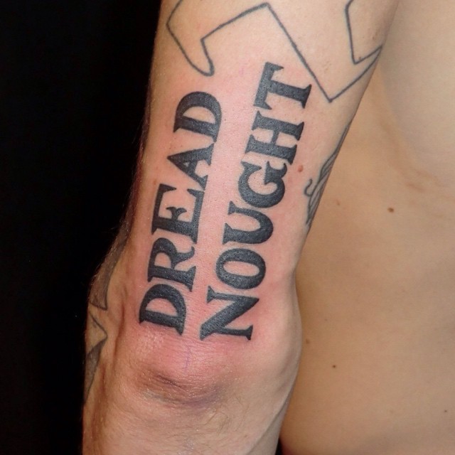 Dread Nought Lettering tattoo on Arm