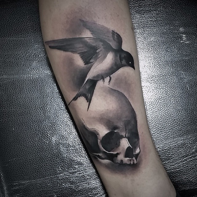 Graphic Skull and Bird Tattoo