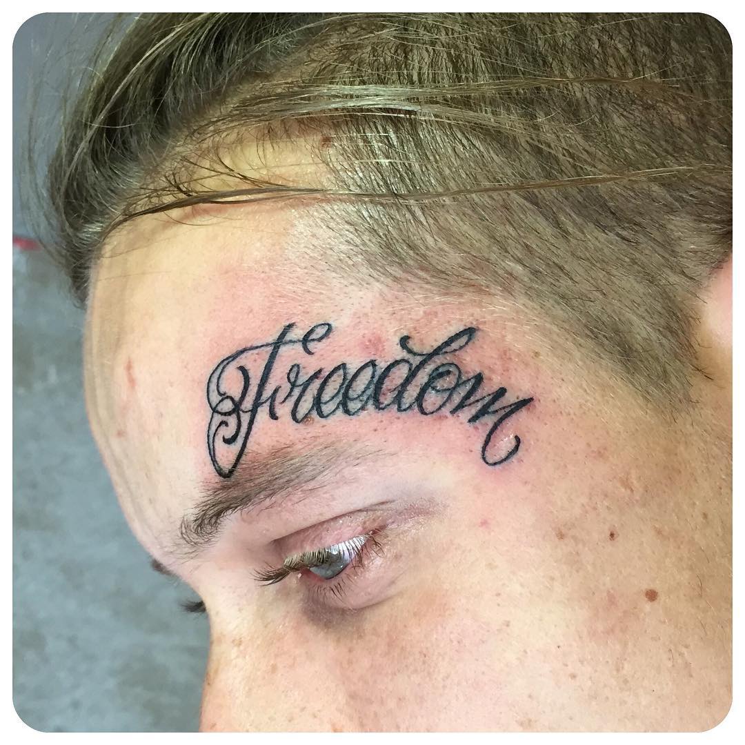 Freedom Lettering Tattoo on Face