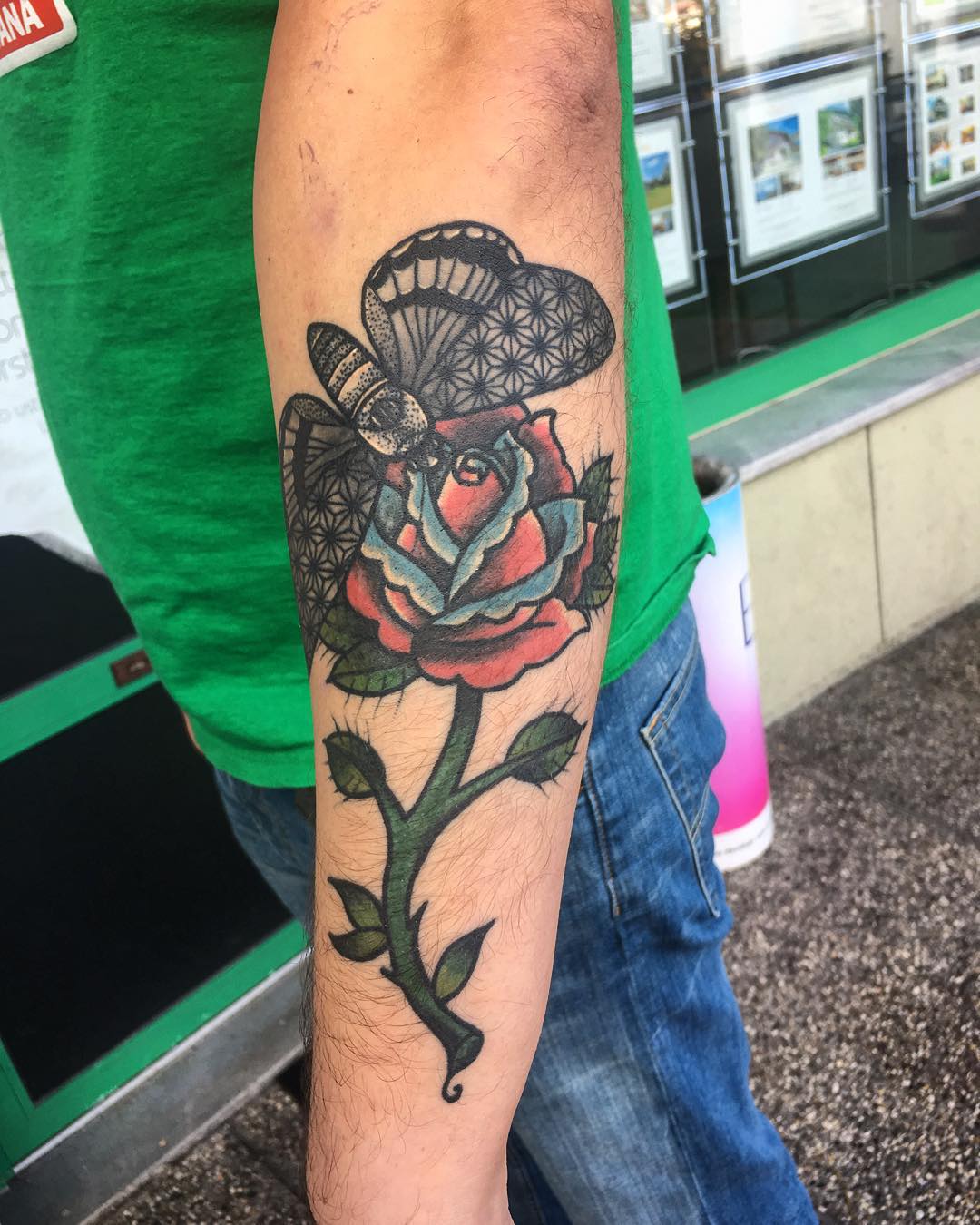 a classical tattoo plot - a butterfly sitting on the rose