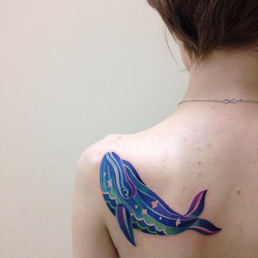 blue whale tattoo on shoulder blade