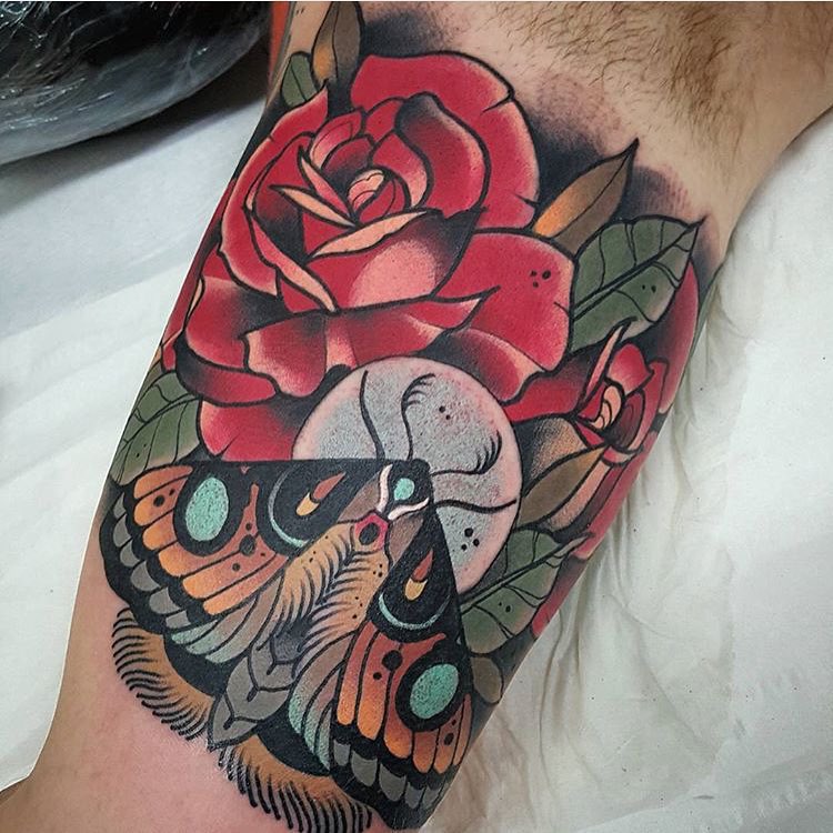moth butterfly and red roses tattoo on bicep