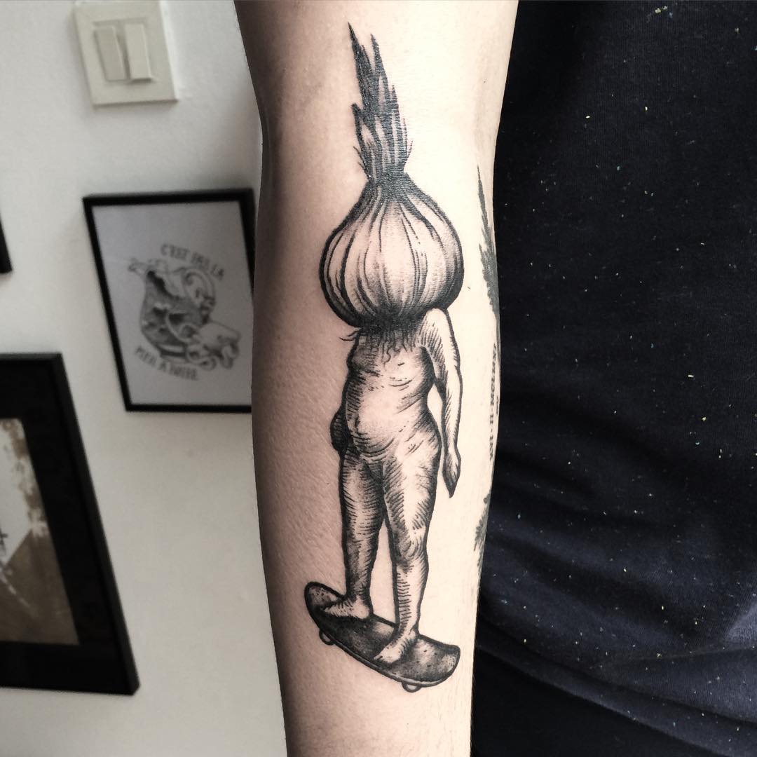 an arm tattoo of a man with an onion insted of the head