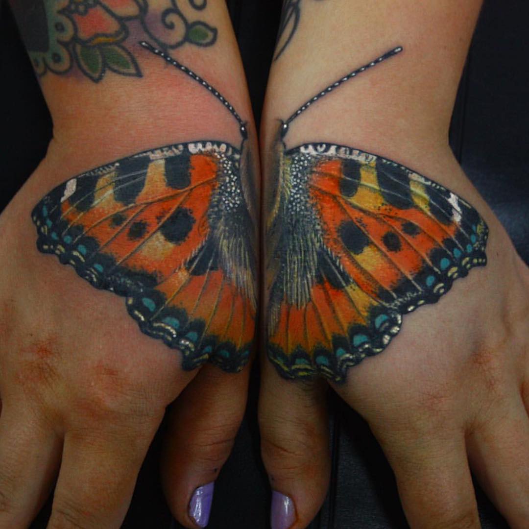 one butterfly tattoo design split in two hand tattoos