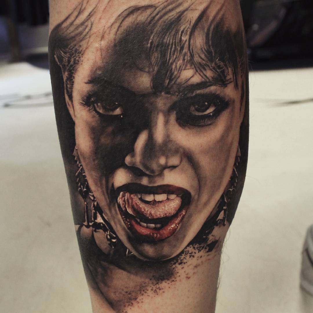 a realistic tattoo depictin a woman with provoking face expression