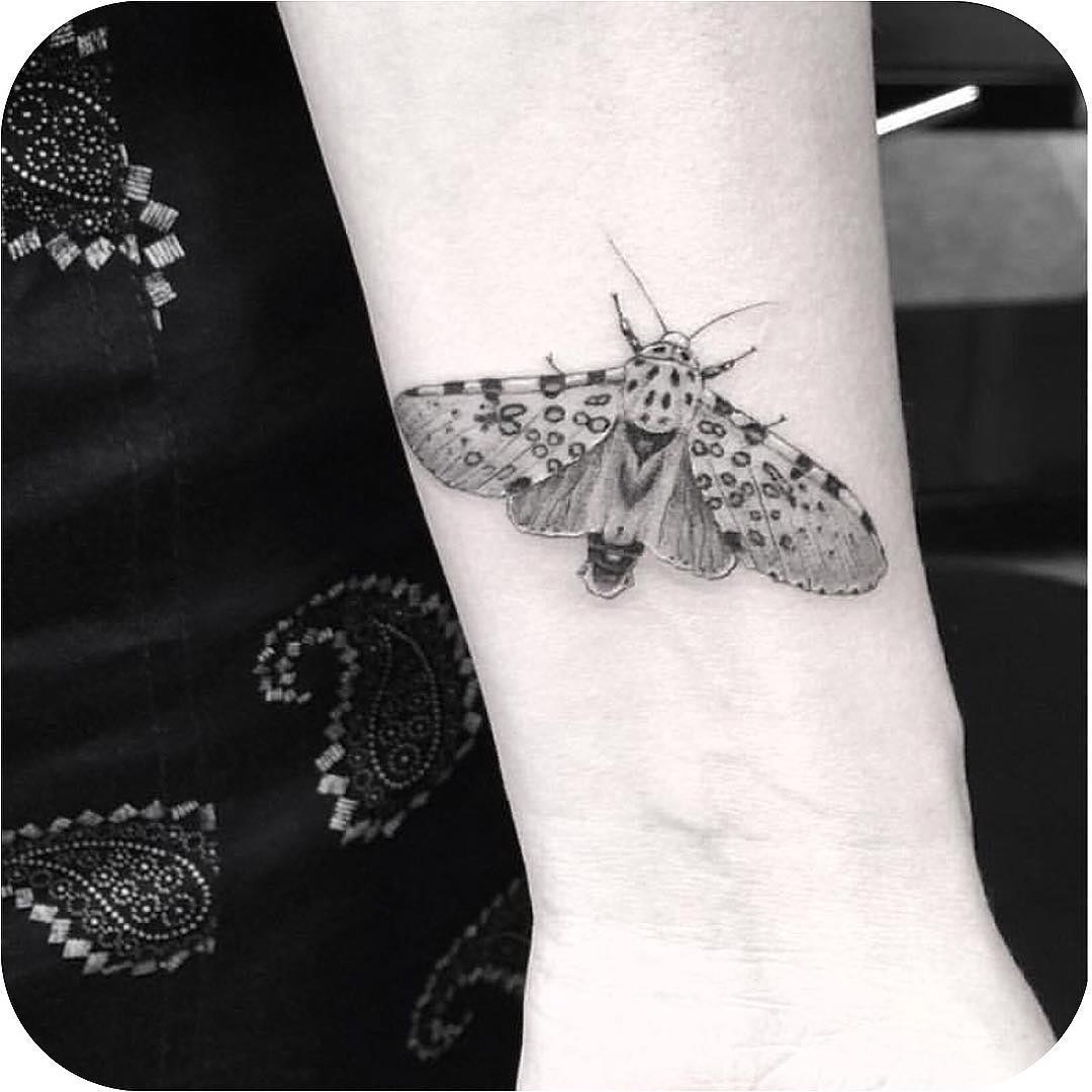 tattoo of a realistic butterfly on wrist