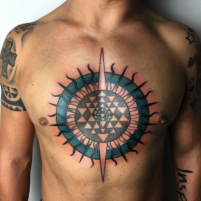 dark colors sun tattoo design on chest