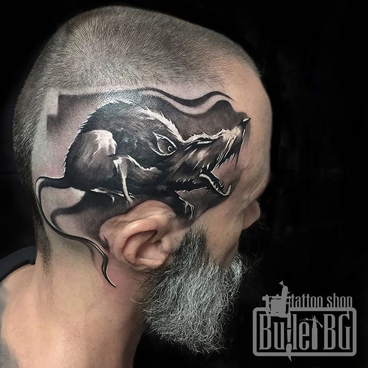 there is a rat in this head tattoo which make the tattoo idea a unique one