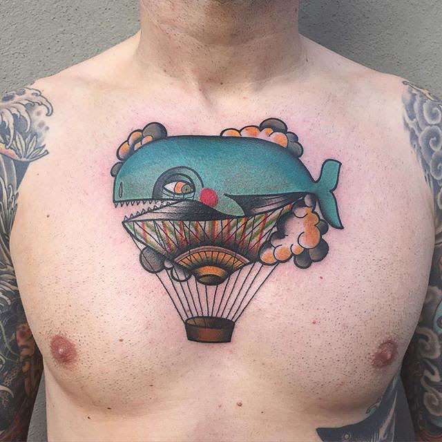 and air balloon tattoo with a whale insted of ballon - chest tattoo