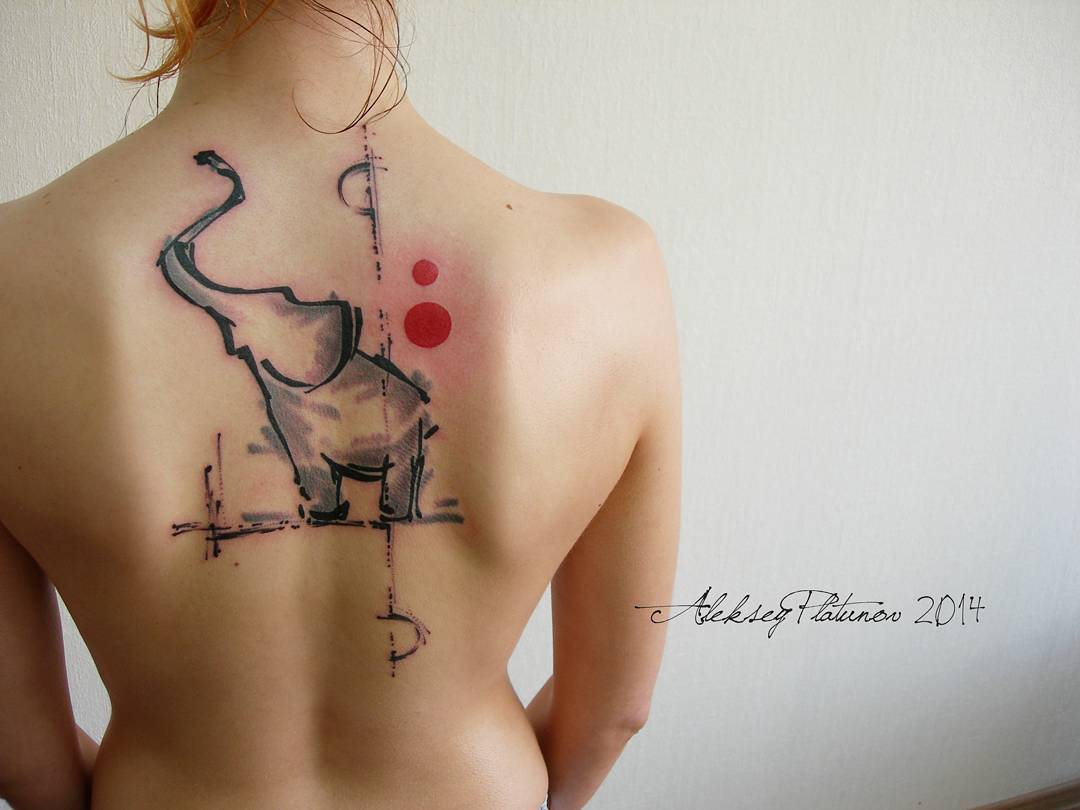 watercolor elephant tattoo on the back of a girl in the area of the shoulder blade