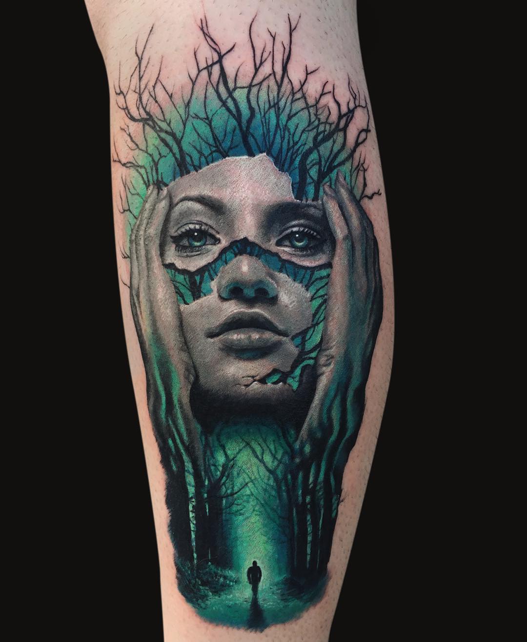a 3D tattoo of a face split into several parts on the dark wood background