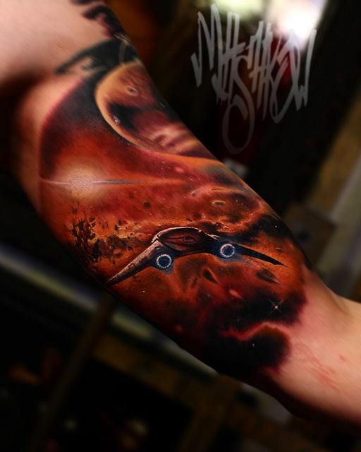 bicep tattoo of space ship