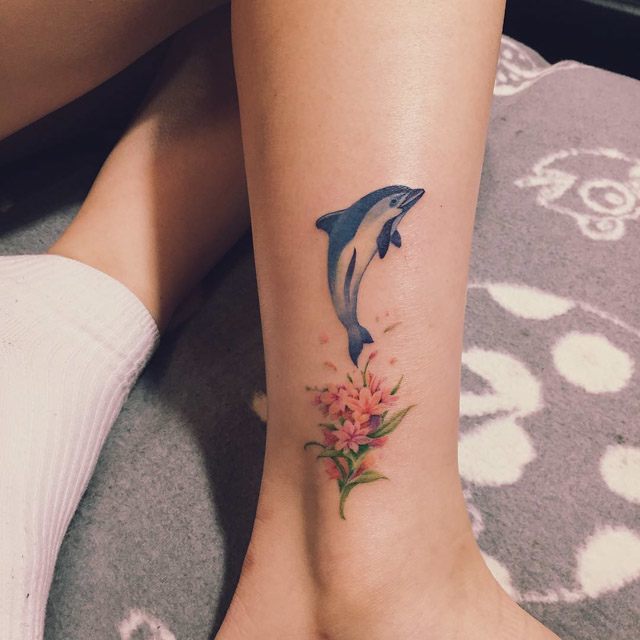dolphin tattoo with flowers