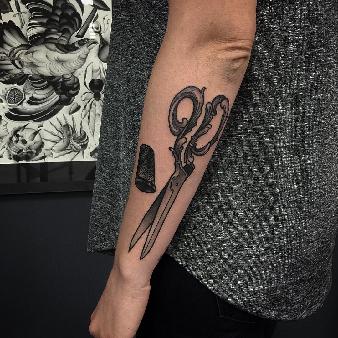 Forearm tattoo of scissors