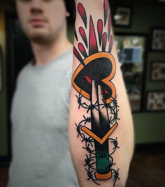 arm traditional hear tattoo