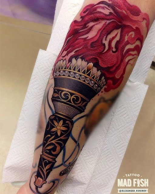 torch tattoo on forearm