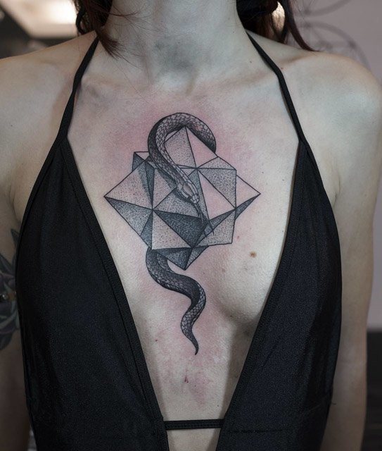 snake tattoo with geometry on chest