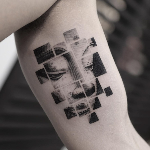 face of buddha inner arm tattoo