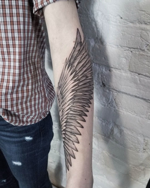 wing tattoo on forearm