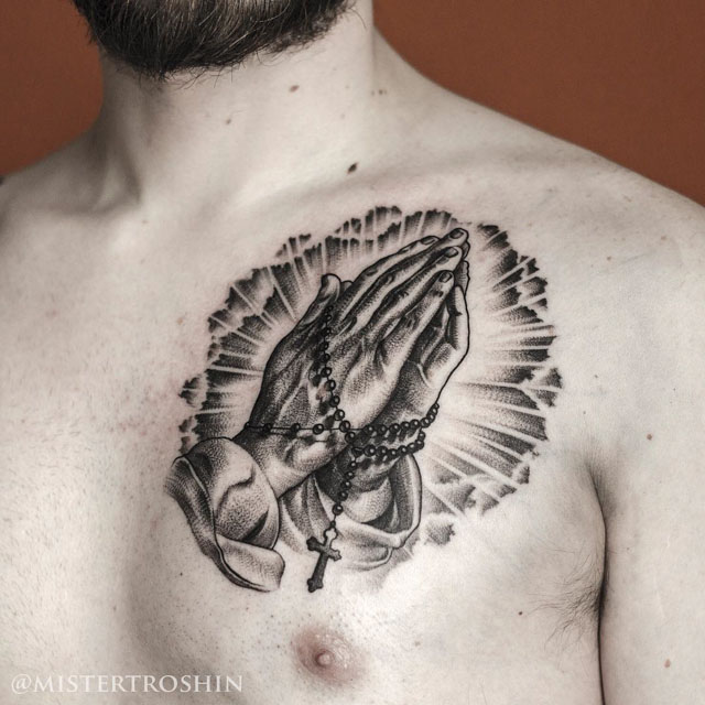 chest praying hands tattoo