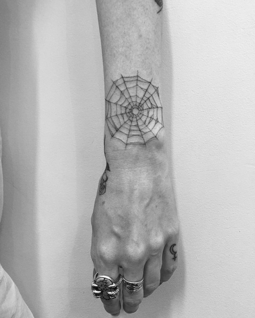 spider web tattoo on wrist