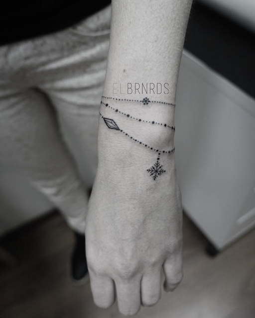 snowflake rosary bracelet tattoo