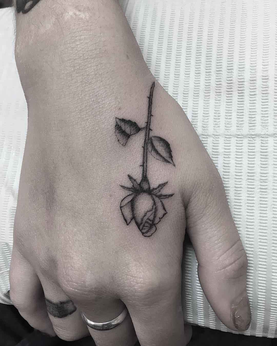 small rose tattoo on hand