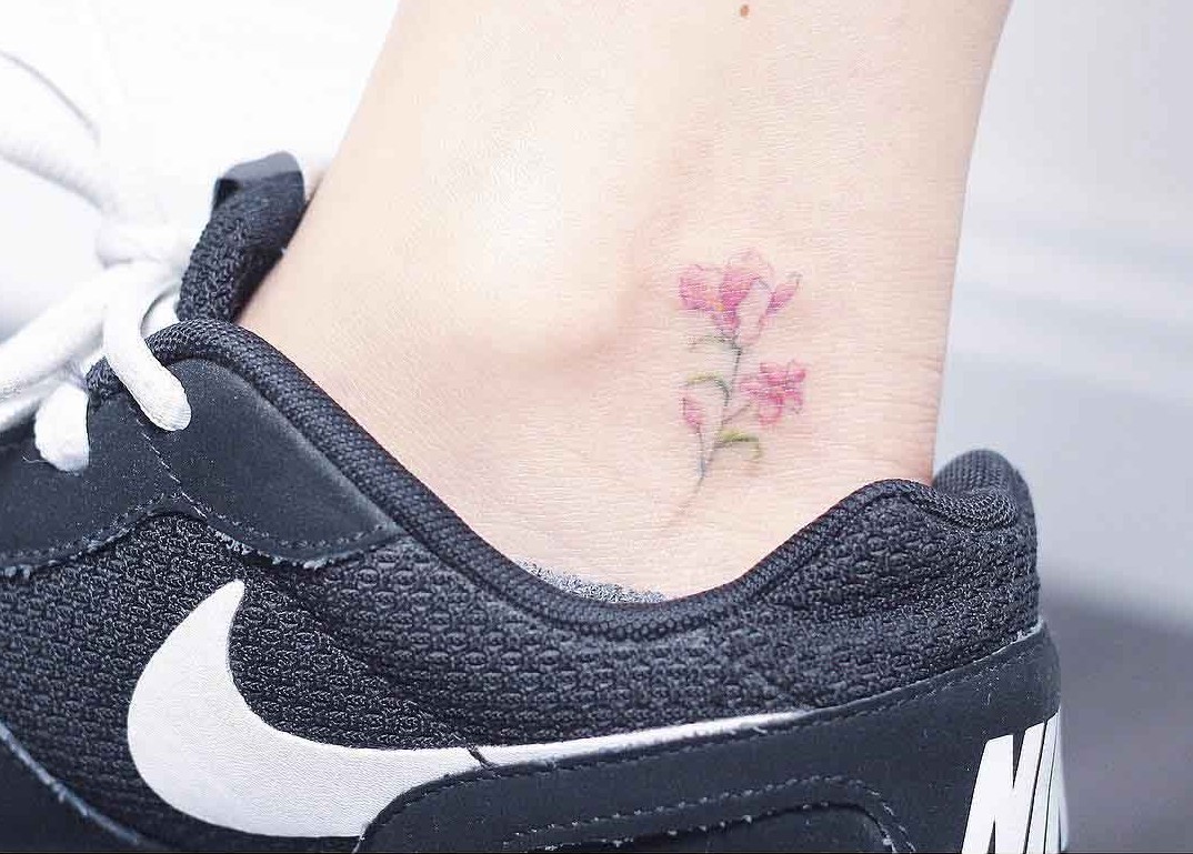 small pink flower tattoo