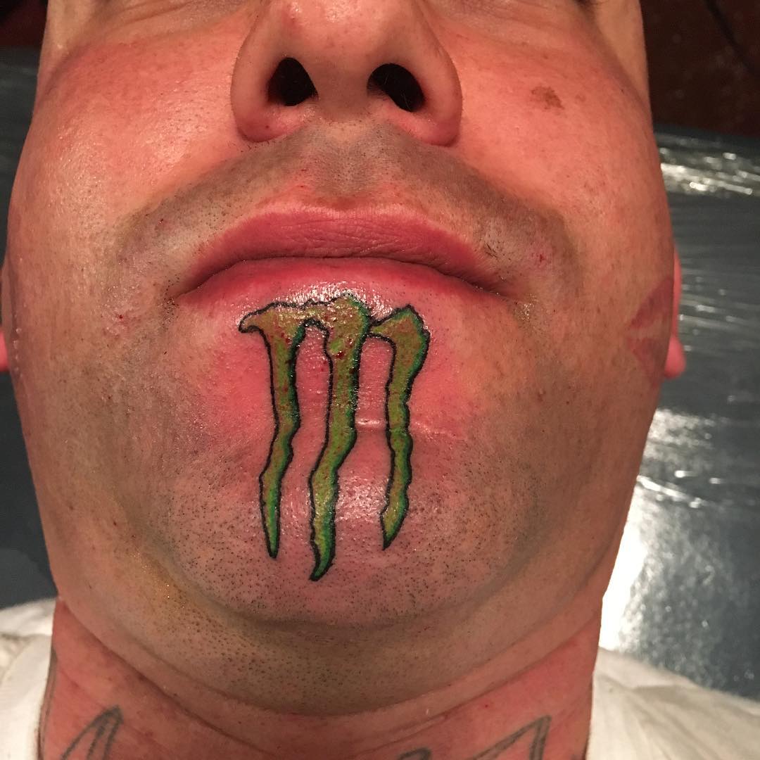Monster Energy Logo Tattoo on Chin by 23inked