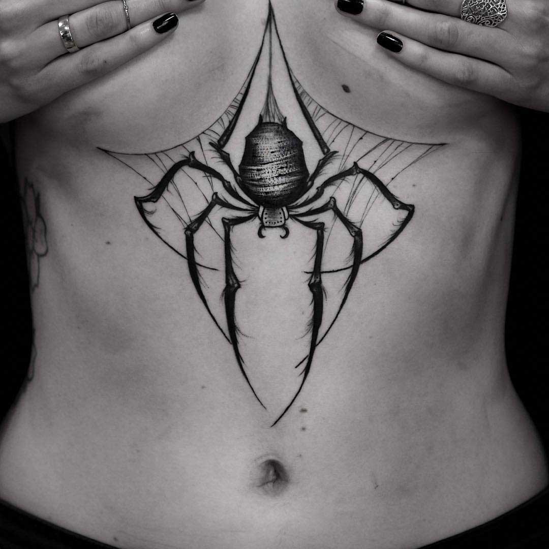 spider tattoo under breasts