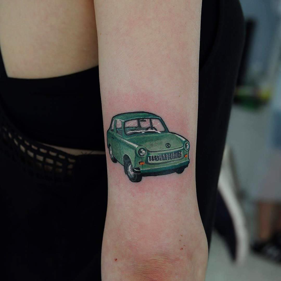 green car tattoo on arm