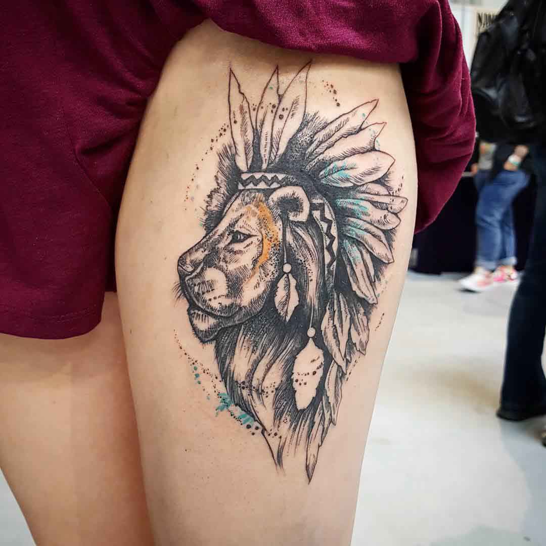 thigh tattoo lion with feathers