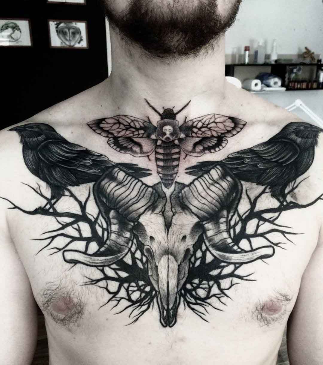ram skull and ravens tattoo on chest