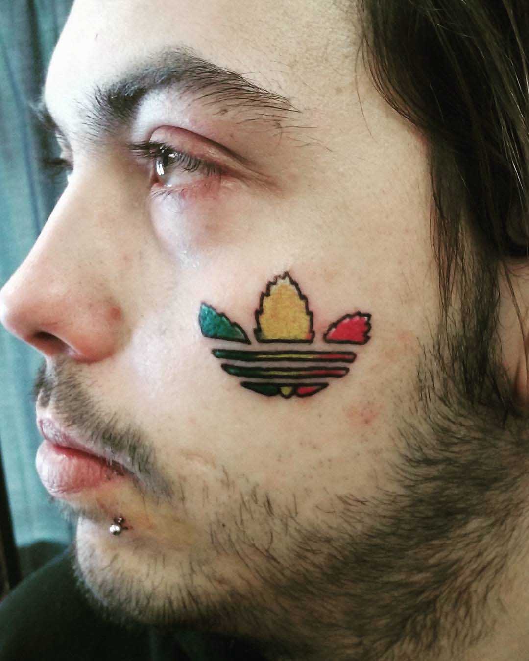 Adidas Logo Tattoo on Face by Kenny Primmer Jr