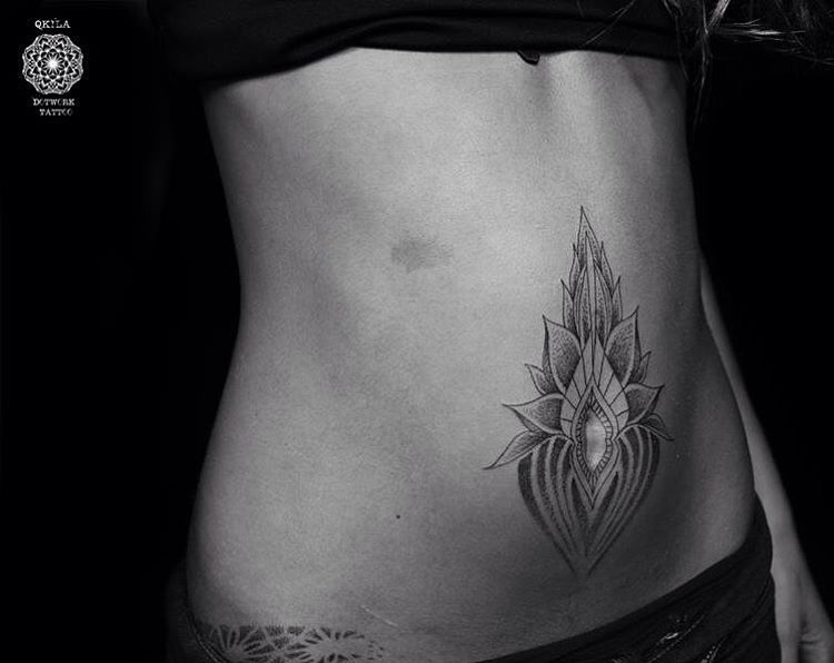 lotus tattoo on belly button