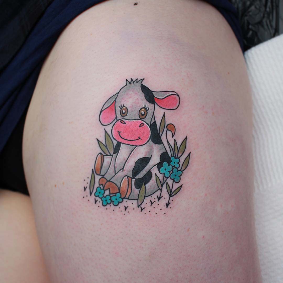 cute tattoo of baby cow on thigh