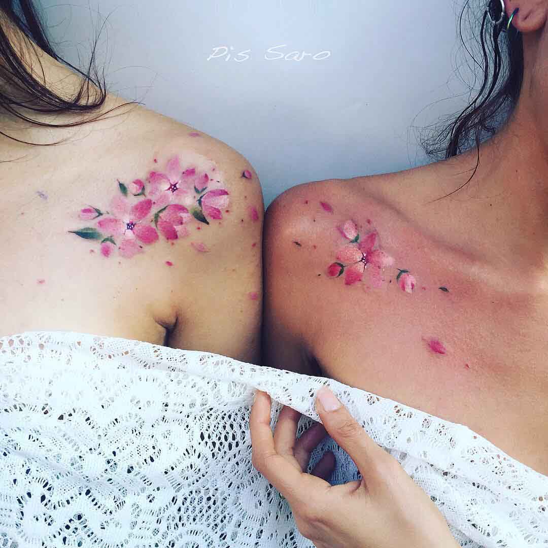 watercolor sakura sisters tattoos on shoulder