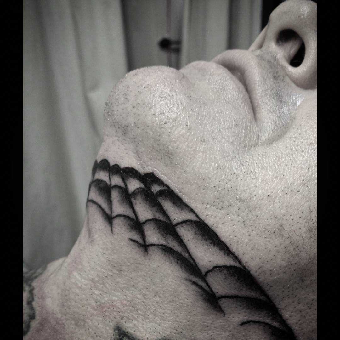 Spider Web Tattoo on Chin by valoniatattoos