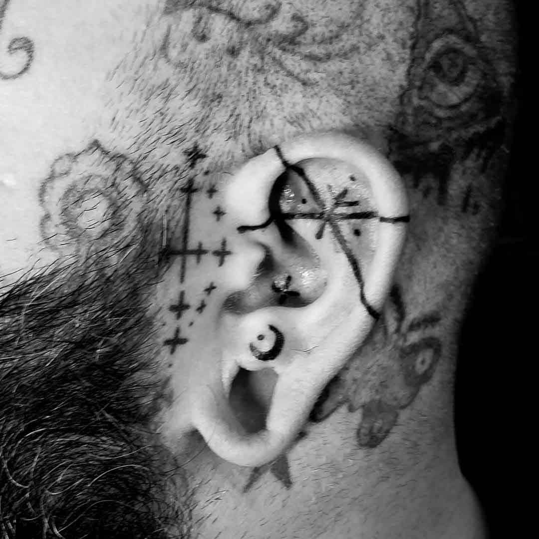 thin lines tattoo on ear