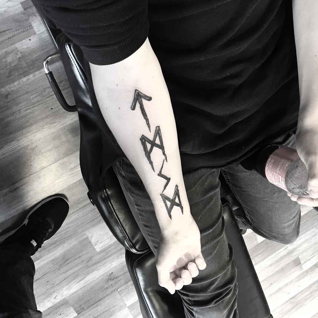 runes tattoo on forearm