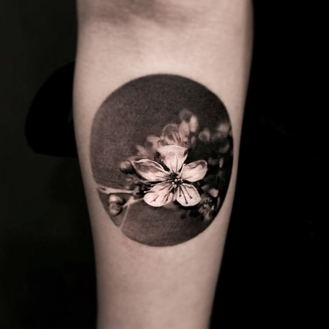 small black and grey flower tattoo