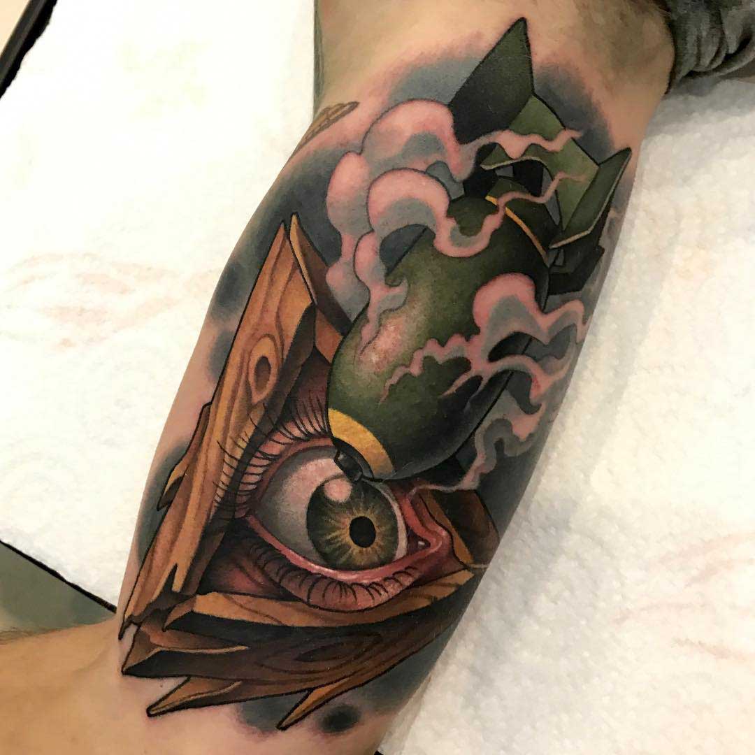 war tattoo eye of providence and bomb new school style on bicep