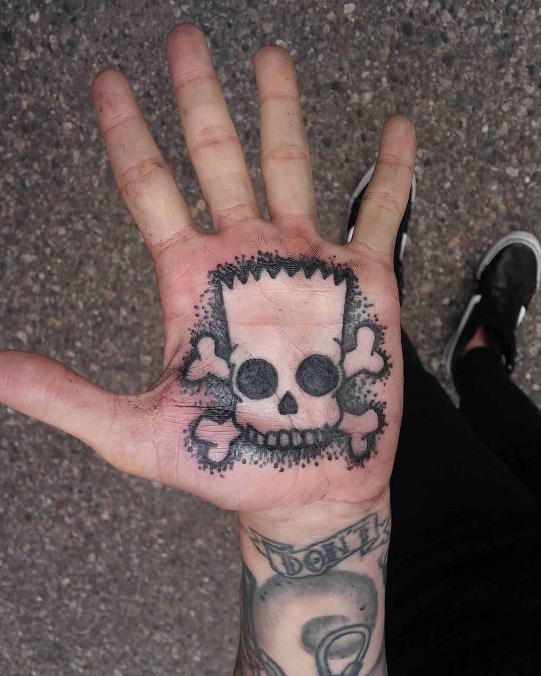 palm tattoo skull of Bart Simpson