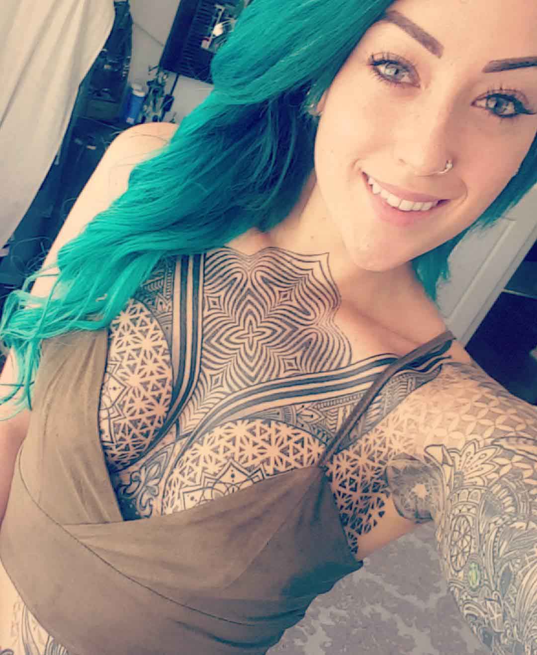 girl's dotwork tattoos on chest and sleeves