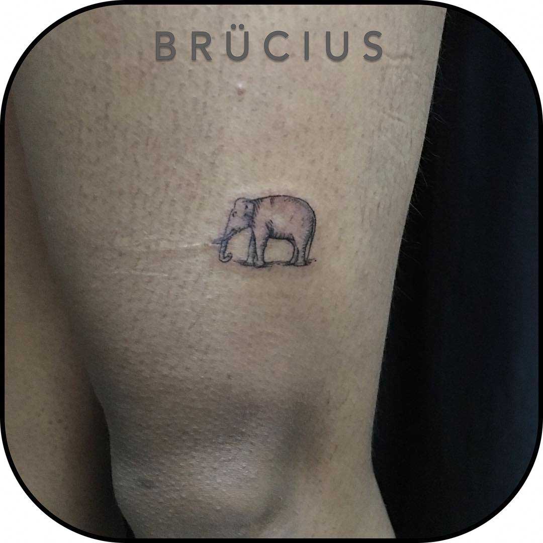 small tattoo elephant above knee