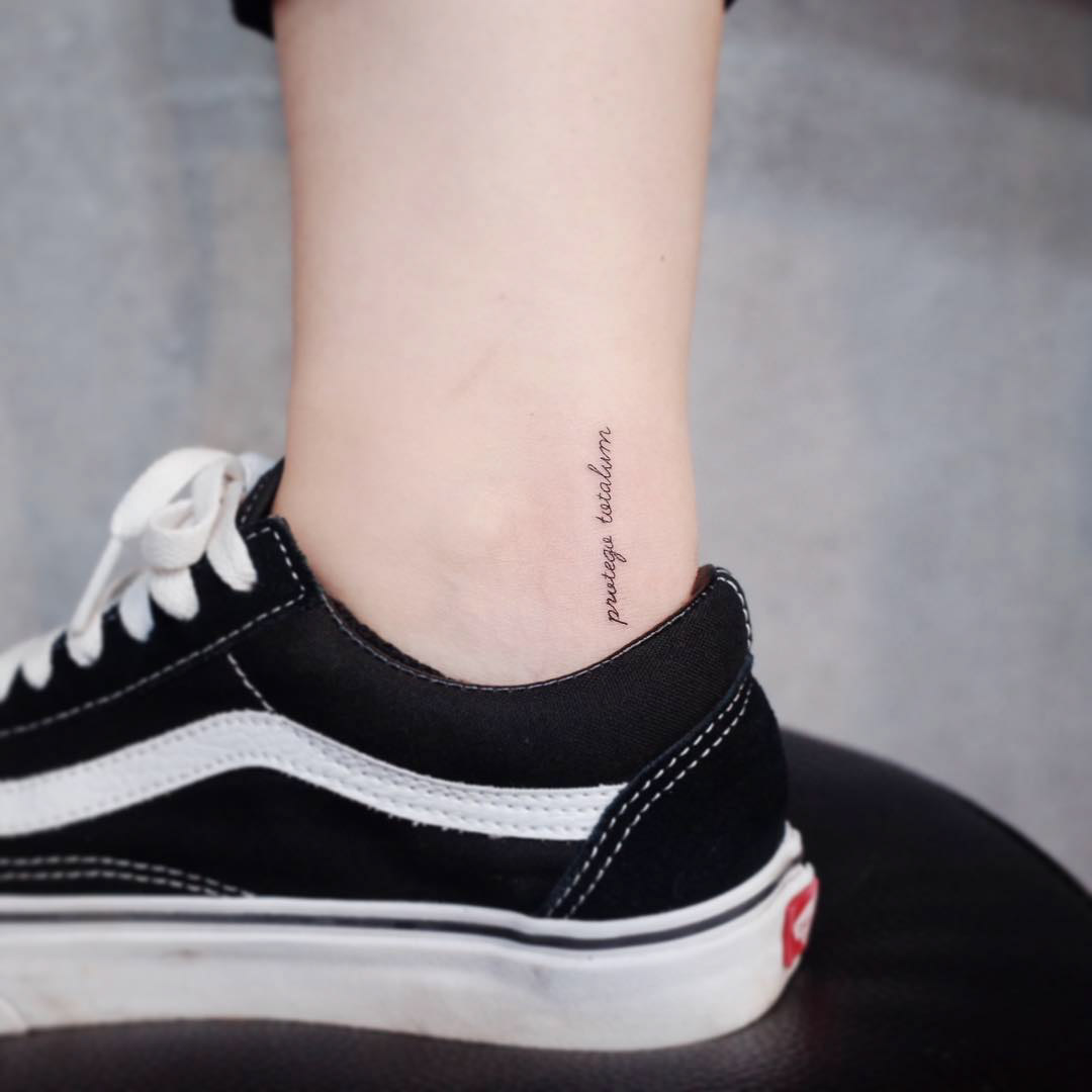 tiny lettering tattoo on ankle