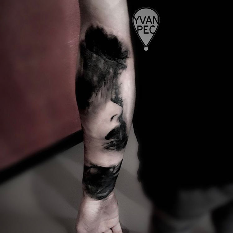 black and grey tattoo on arm