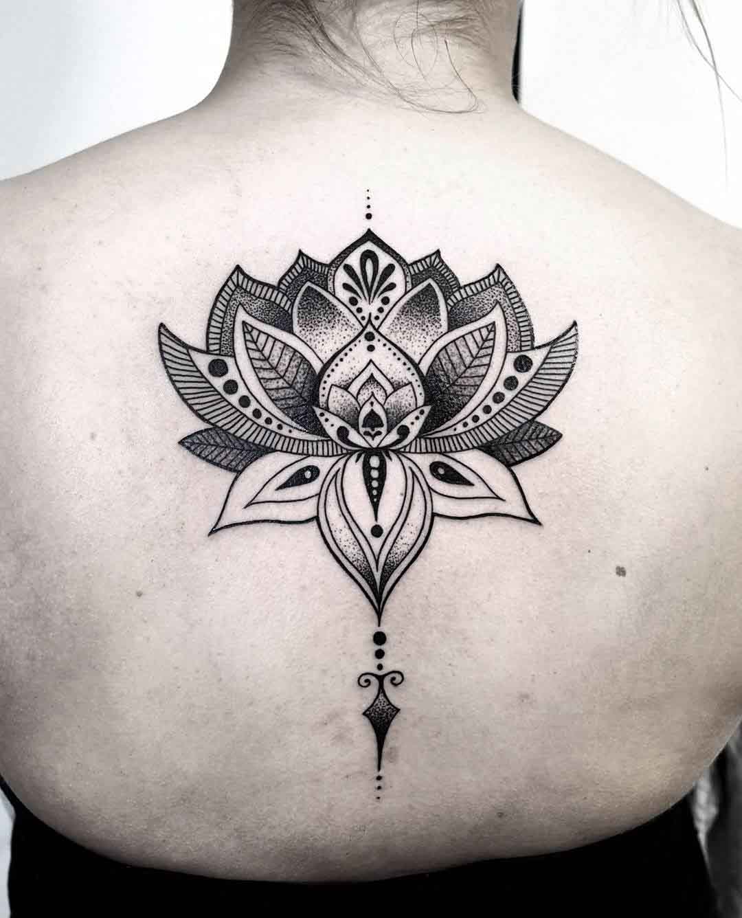 dotwork lotus tattoo on back spine